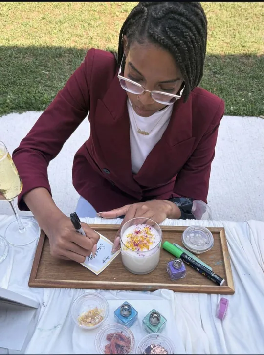 Participant writing a candle label