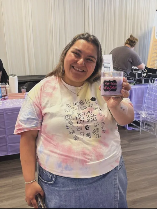 Participant holding a pink candle indoors
